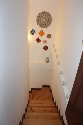 a staircase in a house with a painting on the wall at Oportobestview-River in Porto