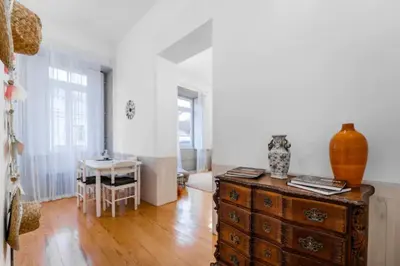 a living room with a wooden dresser and a table at Formosa Apartment with Free Parking and Historic Charm! in Porto