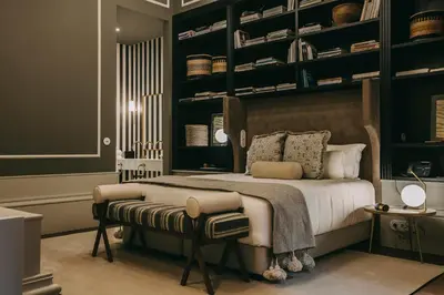 a bedroom with a large bed with black shelves at Torel 1884 Suites & Apartments in Porto