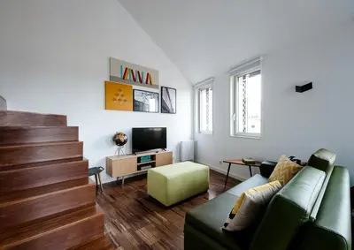 a living room with a couch and a television at PortoSoul Trindade in Porto