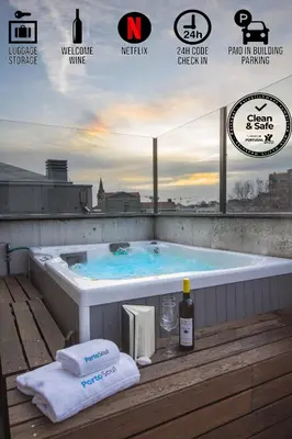 a bath tub with a bottle of wine and a glass at PortoSoul Trindade in Porto