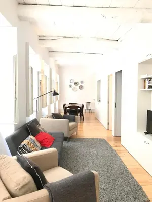 a living room with two couches and a table at Lóios Flat in Porto