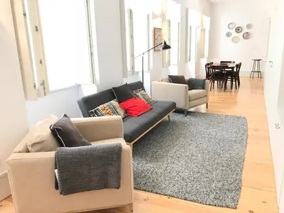 a living room with a couch and a rug at Lóios Flat in Porto