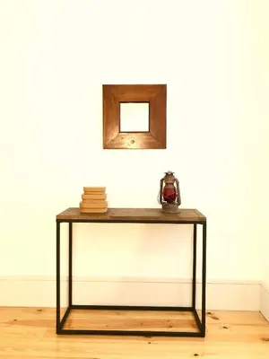 a table against a white wall with a mirror at Lóios Flat in Porto