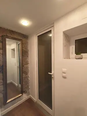 a glass door in a room with a window at Central Apartamento 0 AC Metro Nearby in Porto