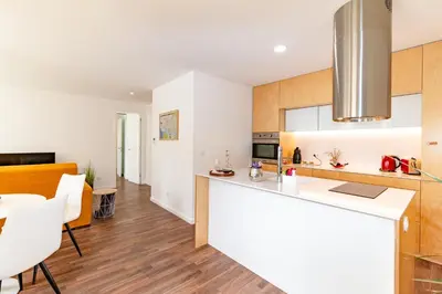 a kitchen and living room with a counter and a dining room at Ceuta Inn Porto in Porto