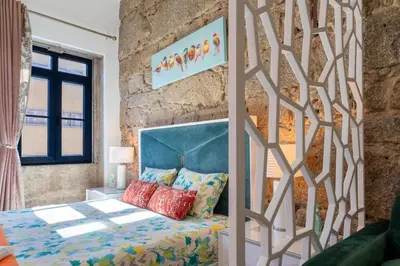 a bedroom with a bed and a table with a lamp at Central Cozy Stay 2 AC Near Metro in Porto