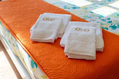 three towels on top of a bed at Central Cozy Stay 2 AC Near Metro in Porto