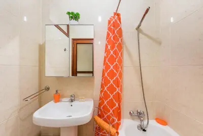 a bathroom with a sink and a giraffe shower curtain at GuestReady - Sweet & Relax Flat in Porto