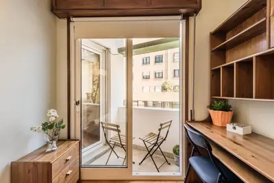 a home office with a glass door leading to a balcony at GuestReady - Sweet & Relax Flat in Porto