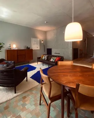 a living room with a table and a couch at Hotel Tipografia do Conto by Casa do Conto in Porto