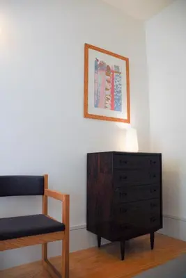 a bedroom with a dresser and a chair and a picture at Amazing City Center Apartment Porto Villa Lóios in Porto