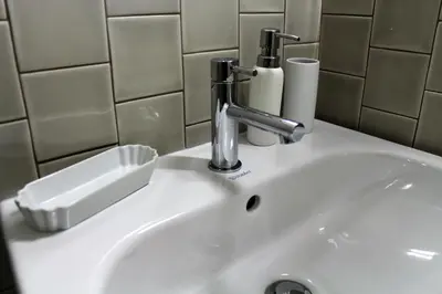 a bathroom sink with a faucet on it at Amazing City Center Apartment Porto Villa Lóios in Porto