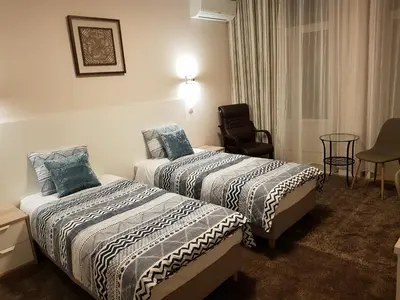 a hotel room with two beds and a chair at HaoBo Porto Center in Porto