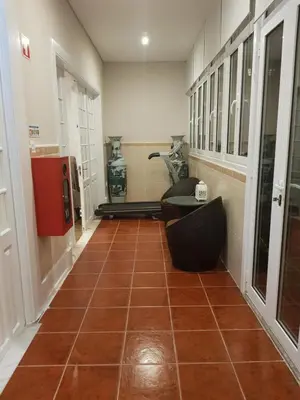 a hallway with a room with a tile floor and a table at HaoBo Porto Center in Porto