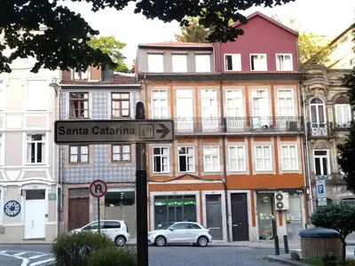 a street sign in front of a building at Santa Catarina Patio Apartment - with washer machine in Porto