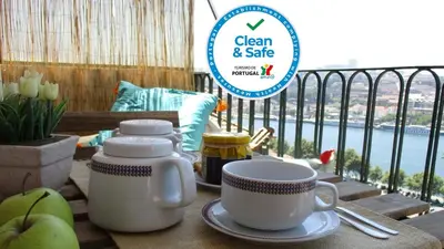 a table with two coffee cups and apples on a balcony at Oportobestview in Porto