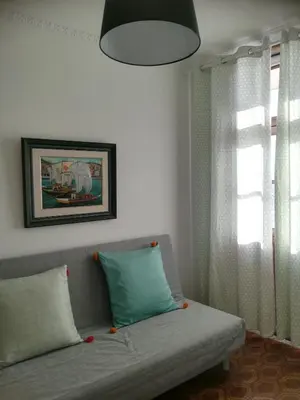 a living room with a couch and a window at Oportobestview in Porto