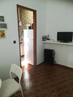 a kitchen with a refrigerator and a chair in a room at Oportobestview in Porto