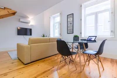 a living room with a table and chairs and a couch at ON Apartments - Palace - Free Parking in Porto