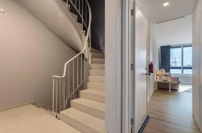 a staircase in a living room with a stair case at Downtown Porto Spot in Porto