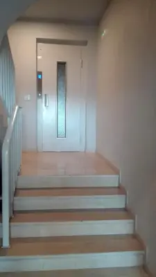 a hallway with stairs leading up to a door at Downtown Porto Spot in Porto