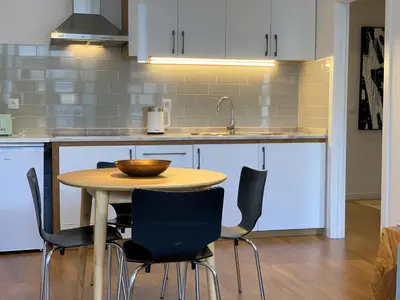 a kitchen with a wooden table and chairs at RIBEIRA OPORTO APARTMENT (NEW) in Porto
