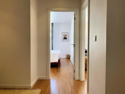 a hallway with a bedroom and a bed in a room at RIBEIRA OPORTO APARTMENT (NEW) in Porto