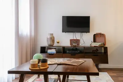 a living room with a tv and a coffee table at Vintage Porto in Porto