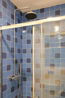 a bathroom with a shower with blue tiles at Vintage Porto in Porto