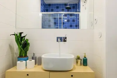 a bathroom with a white sink and blue tiles at Vintage Porto in Porto