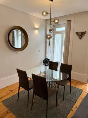 a dining room with a glass table and chairs at ML Apartments Republic in Porto