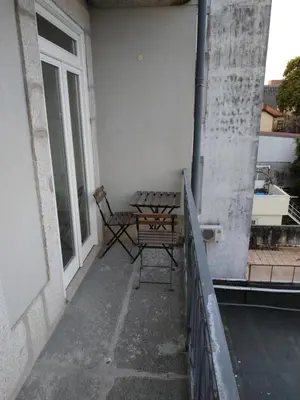 a table and chair on the balcony of a building at ML Apartments Republic in Porto