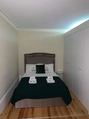 a bedroom with a bed with two towels on it at ML Apartments Republic in Porto