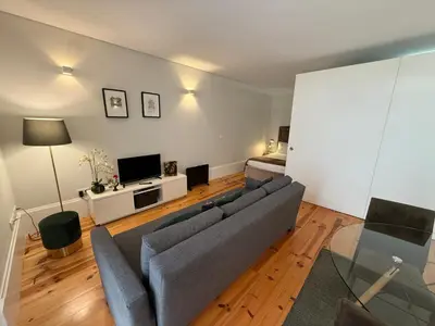 a living room with a couch and a television at ML Apartments Republic in Porto