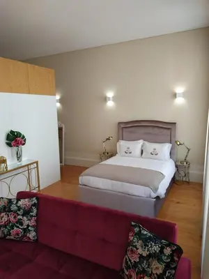 a bedroom with a bed and a couch at ML Apartments River in Porto