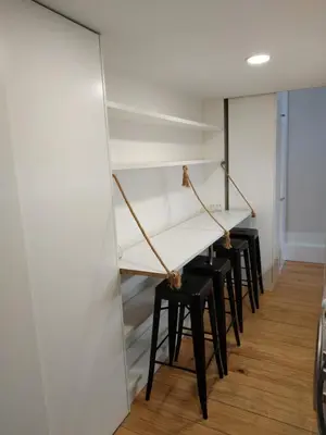 a room with a table and black stools at ML Apartments River in Porto