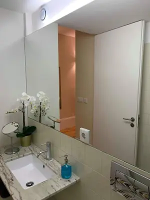 a bathroom with a sink and a large mirror at ML Apartments River in Porto