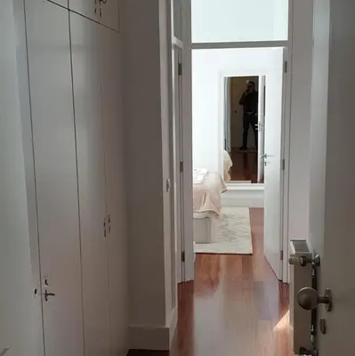 a man taking a picture of a bedroom with a mirror at Lux Ribeira - ALL INCLUDED in Porto