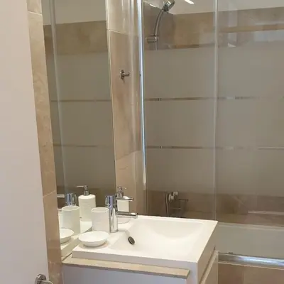a bathroom with a white sink and a shower at Lux Ribeira - ALL INCLUDED in Porto