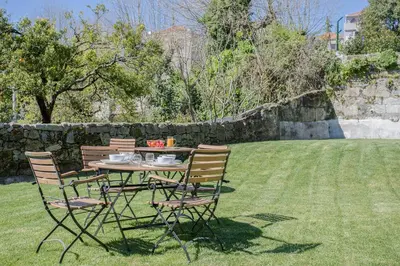 a table and chairs sitting in a yard at Liiiving In Porto | Downtown Luxury Apartments in Porto