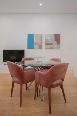 a dining room with a glass table and chairs at Liiiving In Porto | Downtown Luxury Apartments in Porto