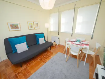 a living room with a couch and a table at Oporto Guest Alegria Flat Downtown in Porto