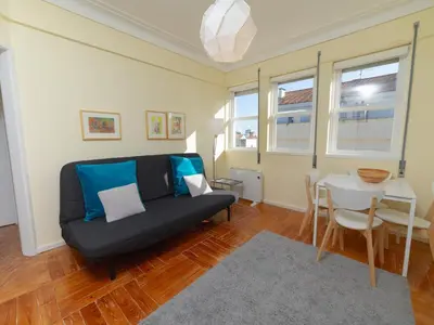 a living room with a couch and a table at Oporto Guest Alegria Flat Downtown in Porto