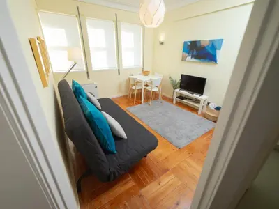 a living room with a couch and a table at Oporto Guest Alegria Flat Downtown in Porto