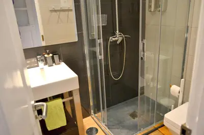 a bathroom with a glass shower and a sink at Downtown Porto Spot - 2 bedrooms in Porto