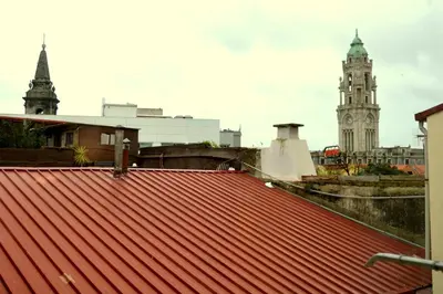 a view of the roofs of buildings and a clock tower at Downtown Porto Spot - 2 bedrooms in Porto