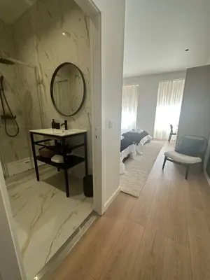a bathroom with a vanity and a mirror in a room at Apartamentos sobre o Douro in Porto