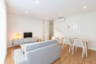 a living room with a couch and a table at Oporto Palace Apartments in Porto