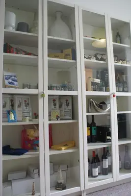a pantry with white shelves filled with items at O'Porto Seven - Guest House in Porto